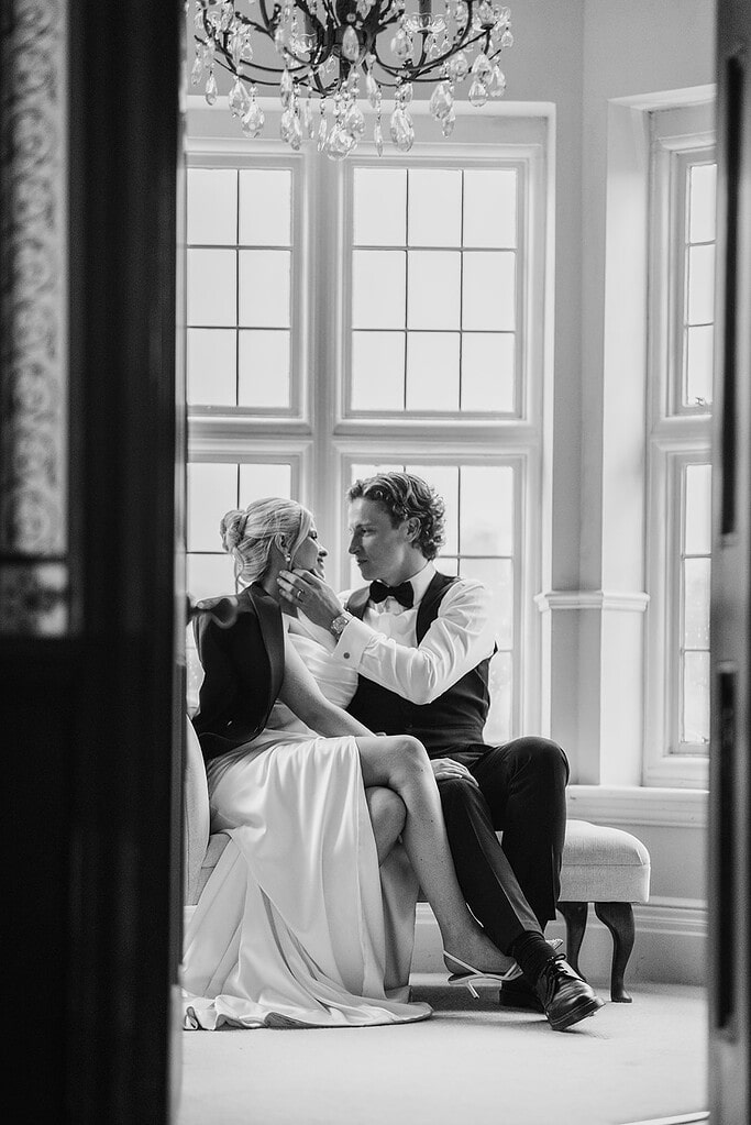 Baddow Park House wedding photography; black and white fine art wedding portrait; bride and groom on chaise longue; luxury Essex wedding photographer.